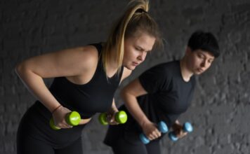 side view people training gym